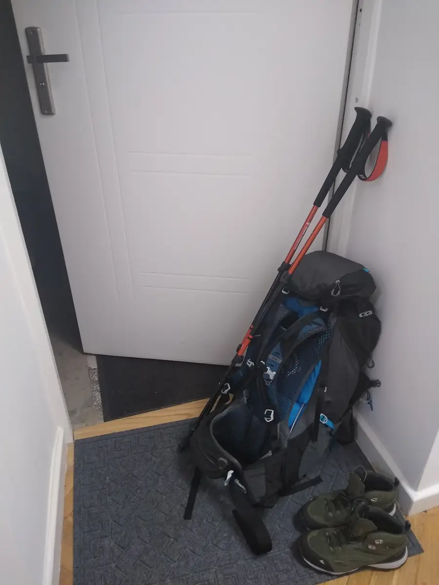 Hiking gear laid out for Acadia: backpack, layers, and windproof jacket