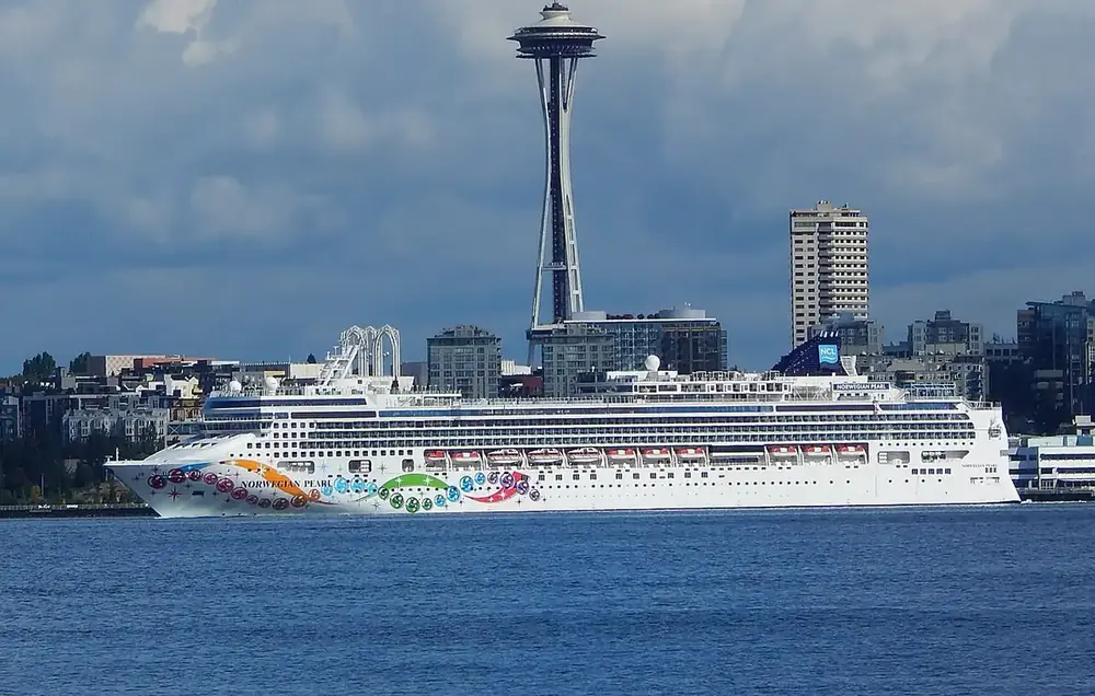 A cruise ship at the Seattle waterfront with the Space Needle