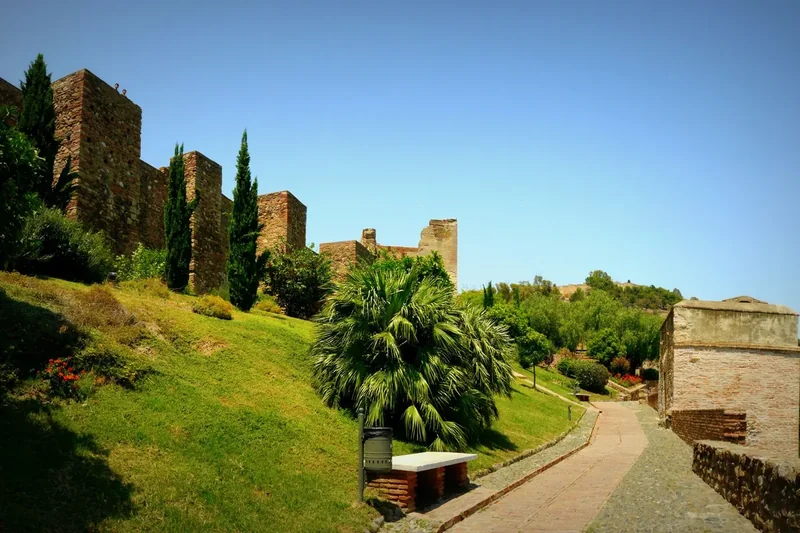 Brick and stone walls and a gate inside the Alcazaba of Málaga