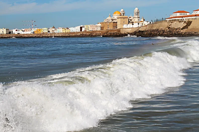 The cathedral of Cádiz with its dome and towers above the seawall