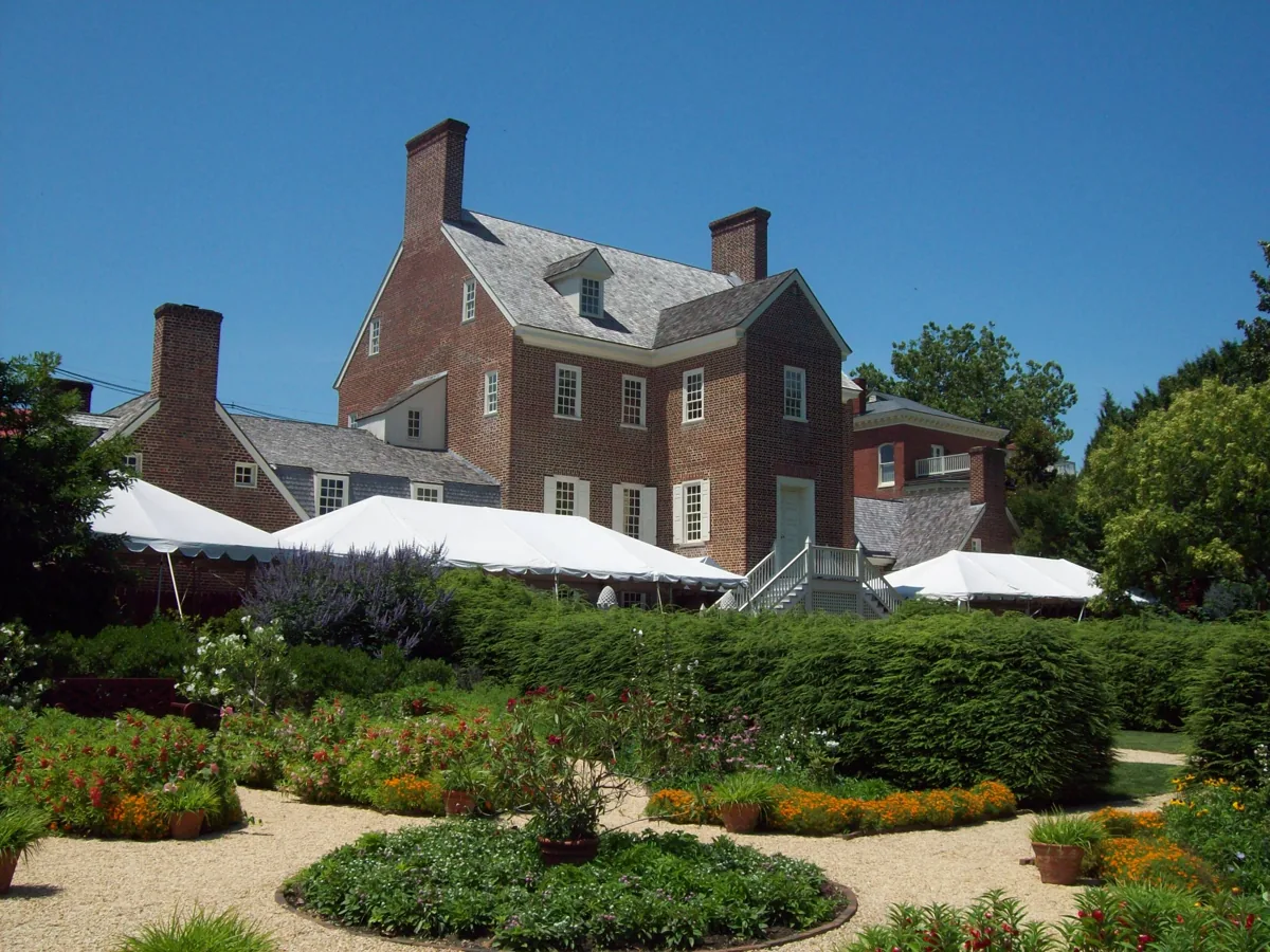 The red-brick William Paca House seen from its garden, with flower beds and lawns in summer