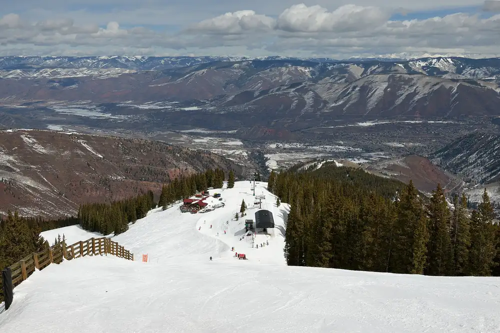 Groomed ski run looking down over the valley from Aspen Snowmass