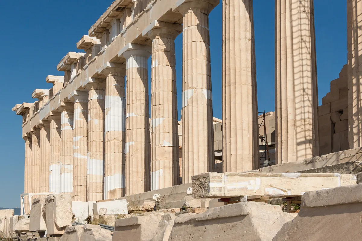 The western colonnade of the Parthenon in bright sun against a blue sky