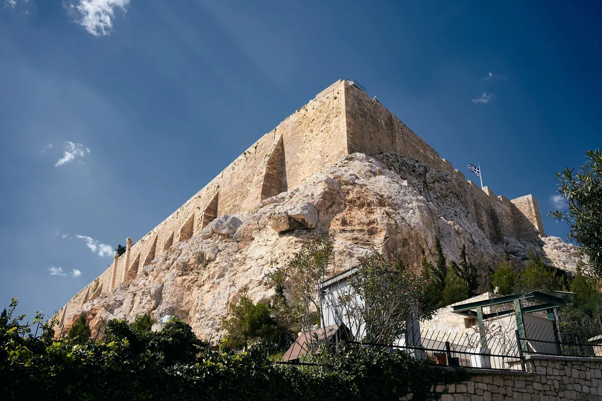 The walls of the Acropolis rock seen from below on Thrasyllou Street in Plaka