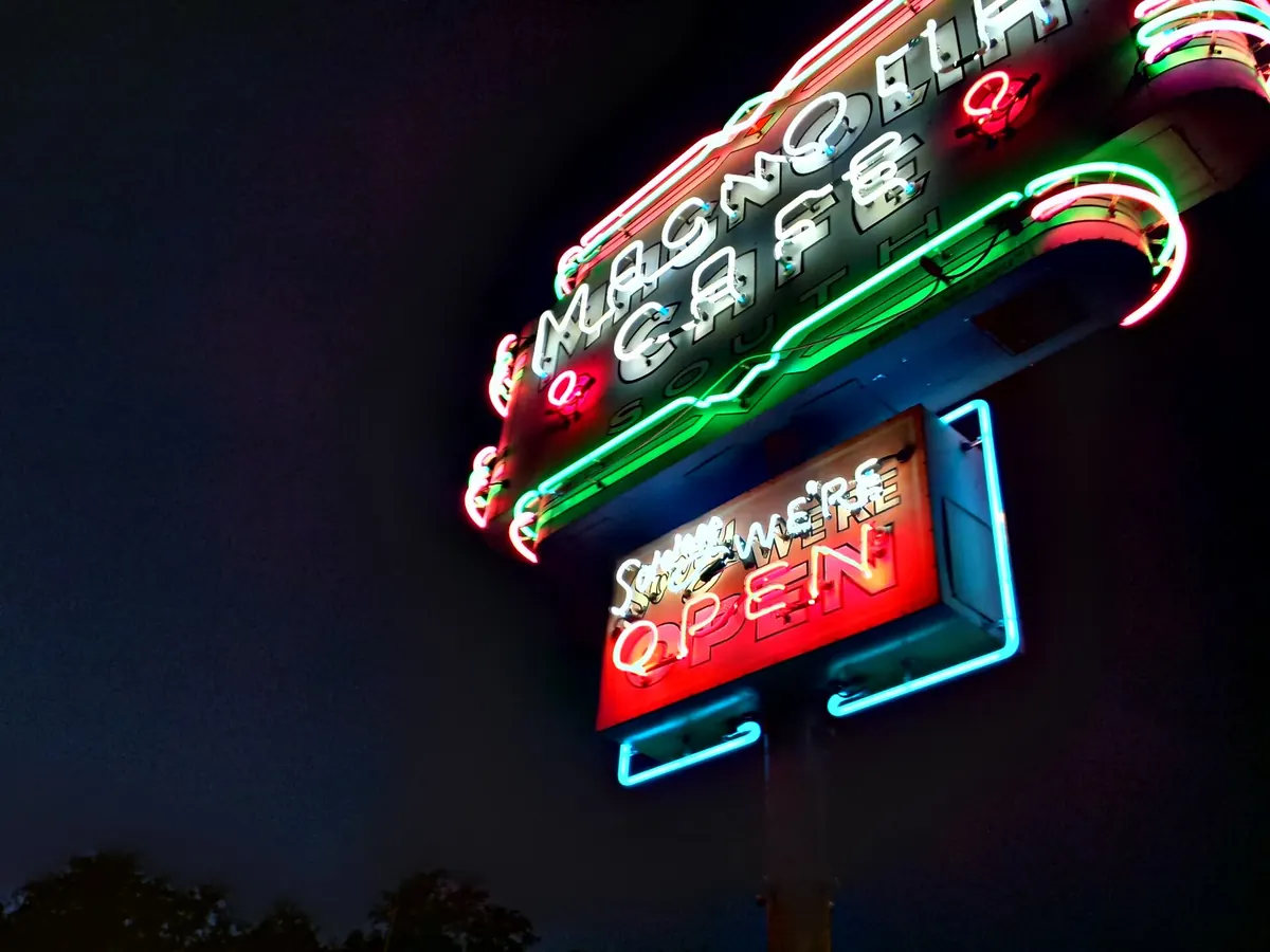 The Magnolia Cafe neon sign glowing at night in Austin