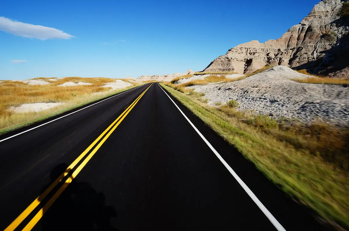 Badlands Road running toward striated canyon walls
