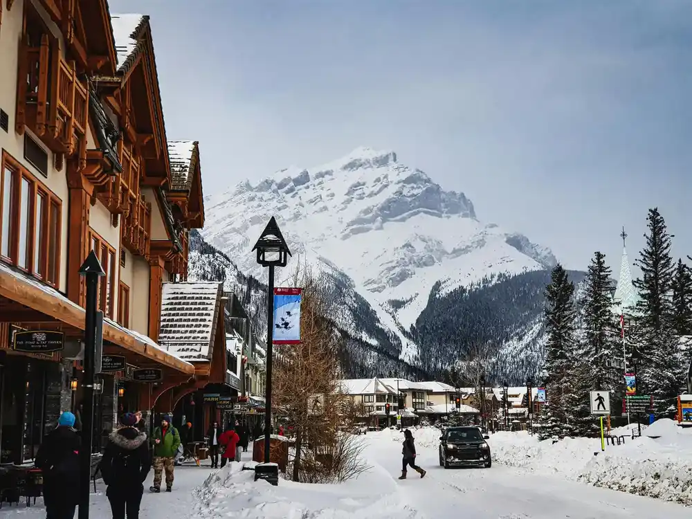 Banff Avenue in winter with Cascade Mountain behind it