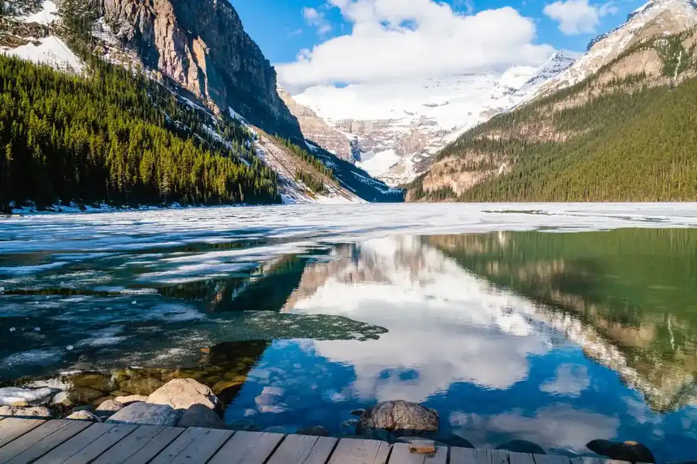 Lake Louise frozen in winter with Victoria Glacier at the far end