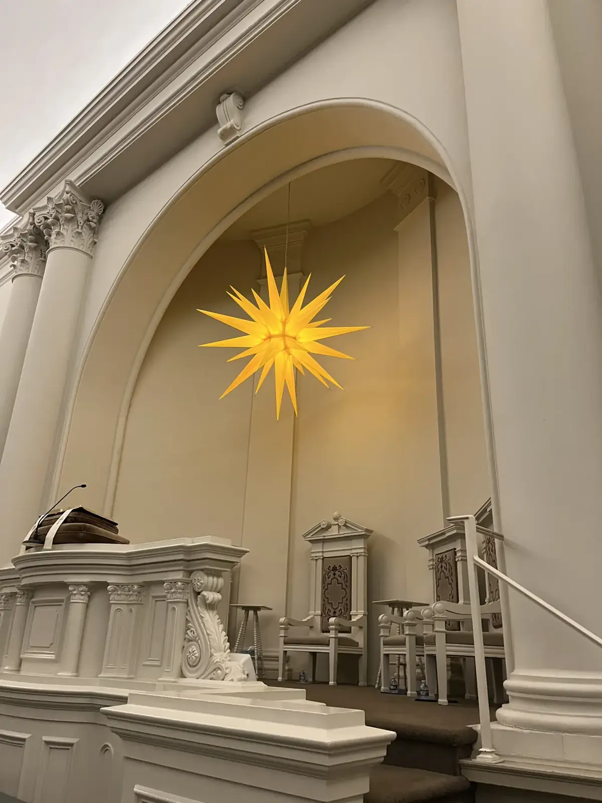A glowing Moravian star above a house in Bethlehem at Christmas