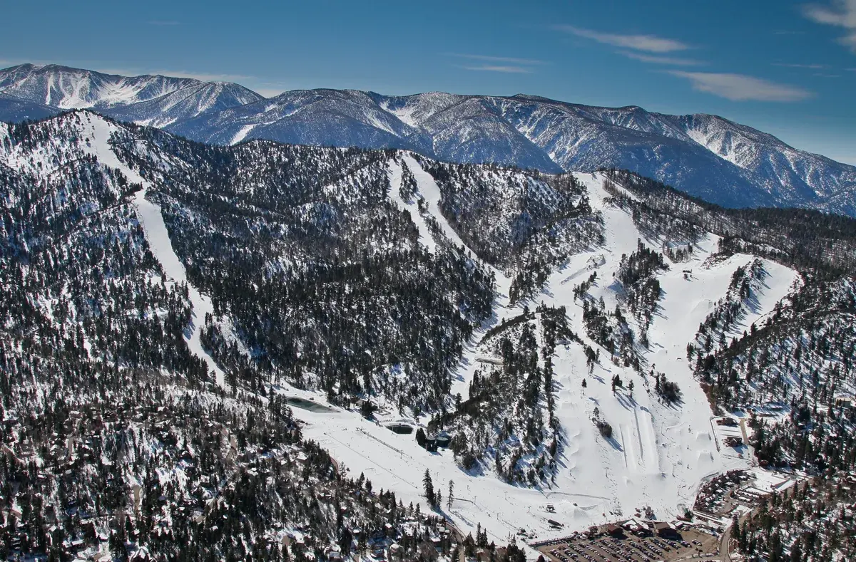 Snowy ski runs cutting through pine forest on Bear Mountain above Big Bear Lake