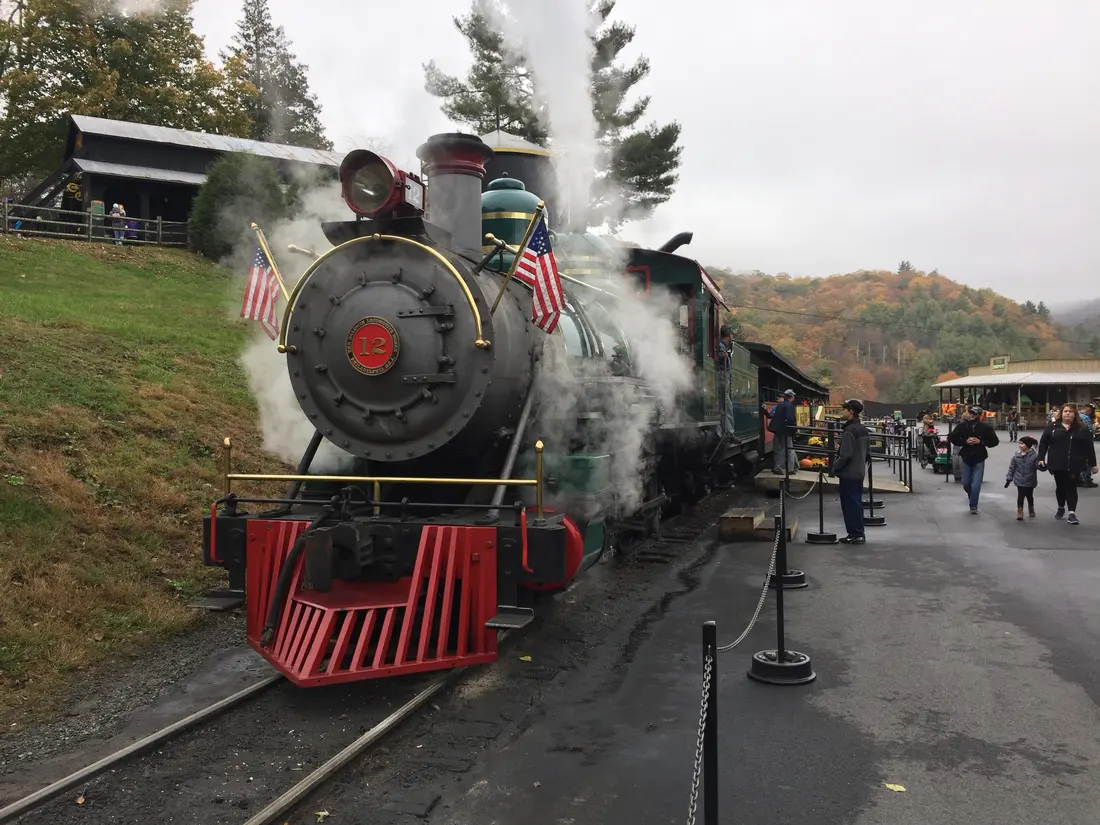 Tweetsie Railroad's Locomotive No. 12 with steam up, families boarding