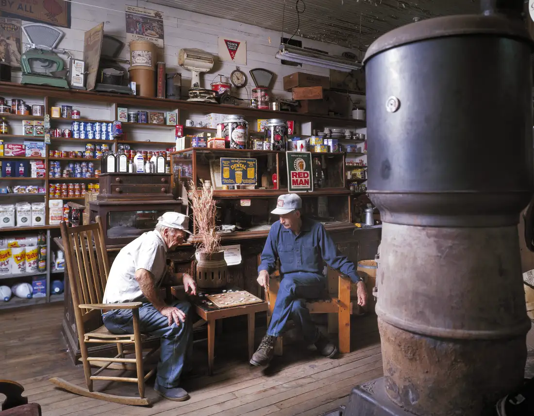 Two men playing checkers by the potbelly stove inside the Mast General Store