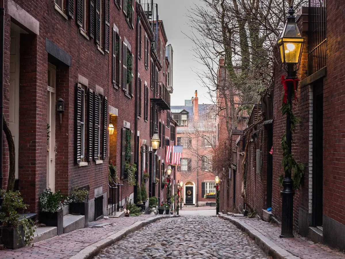 Acorn Street on Beacon Hill, a narrow cobblestone lane between brick rowhouses