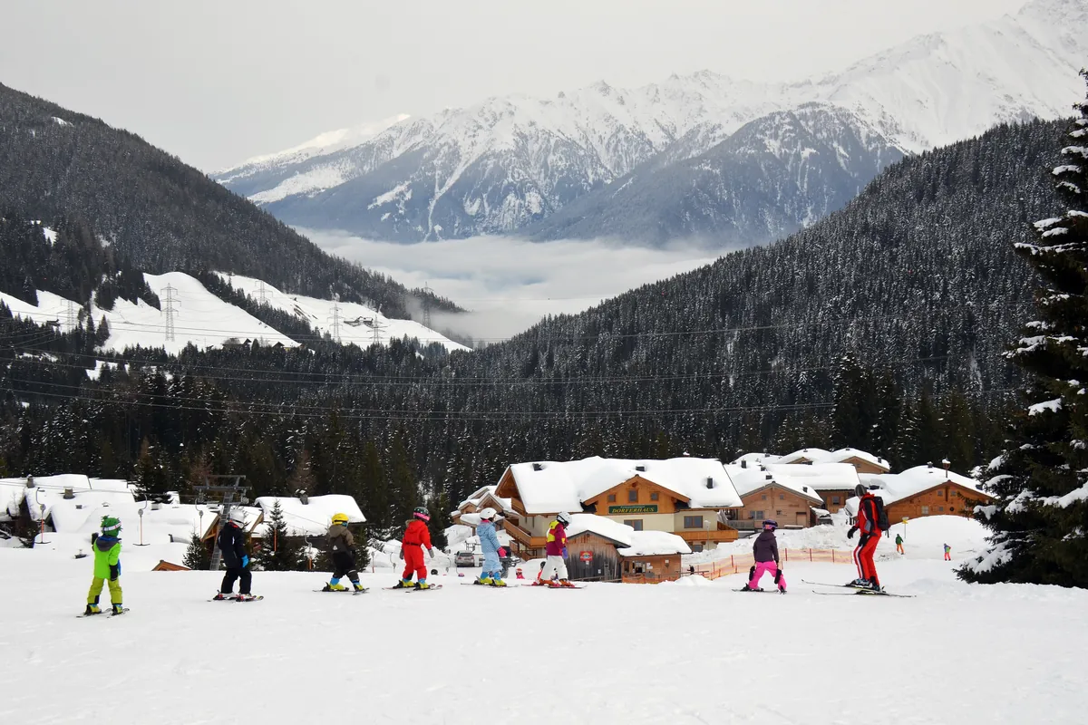 Children learning to ski on a gentle beginners’ slope