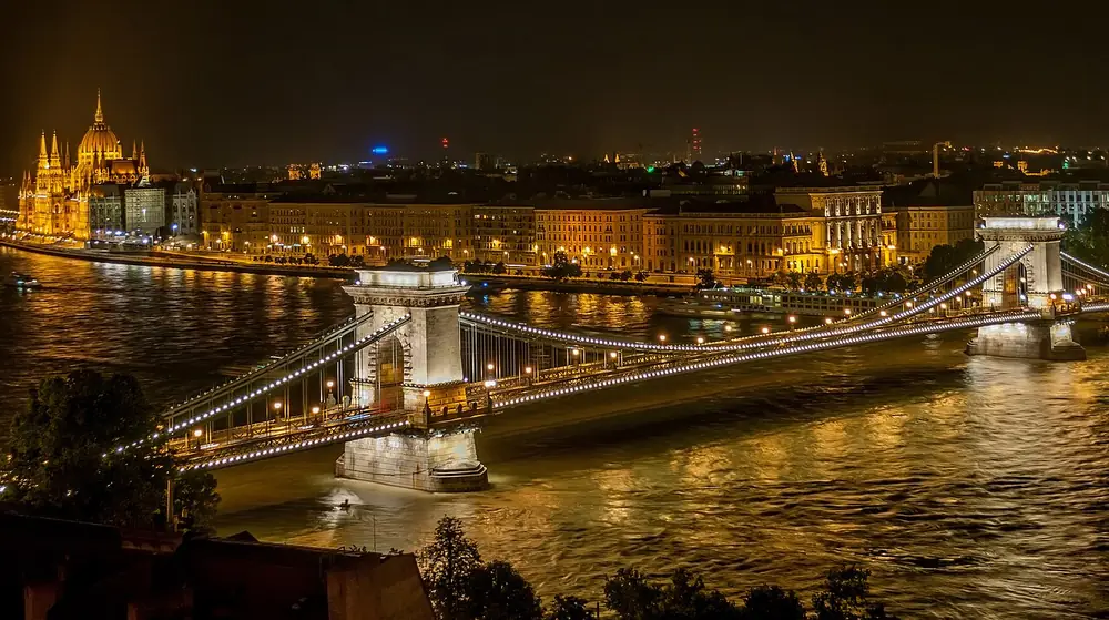 The Széchenyi Chain Bridge lit up at night over the Danube