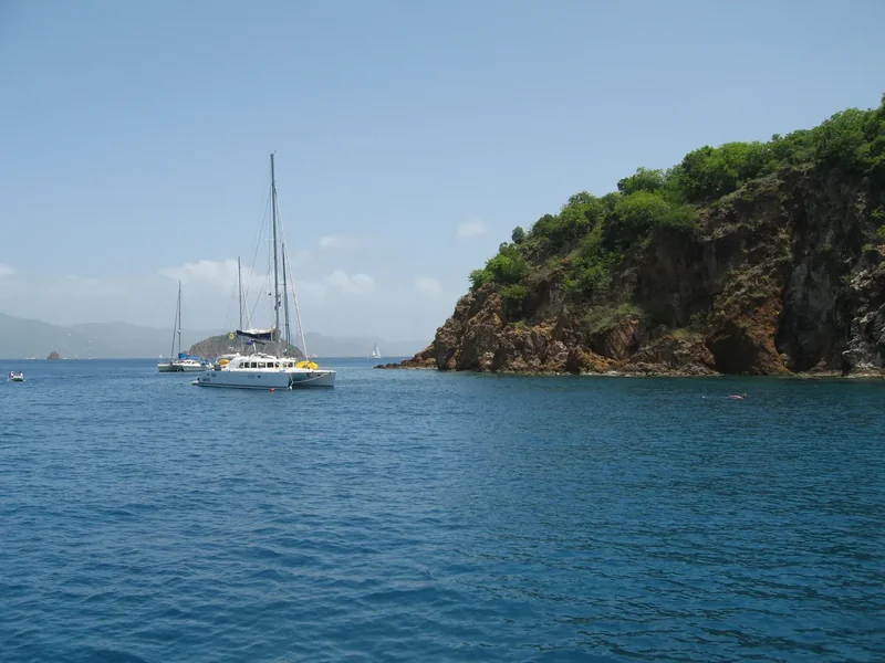 The sea caves at Treasure Point on Norman Island with snorkelers and a dinghy