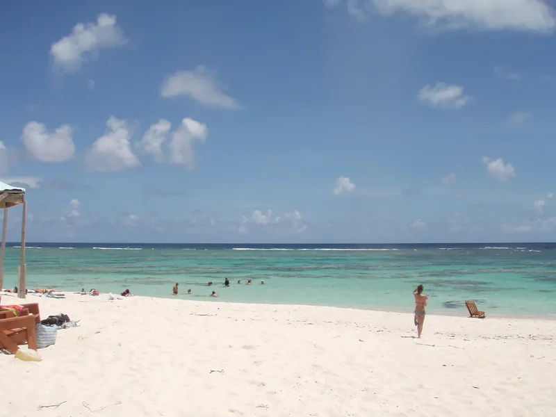 A flat salt pond and scrub on Anegada under a wide sky
