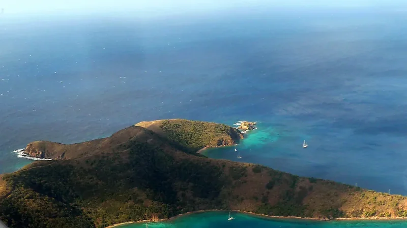 The green west end of Norman Island above blue water