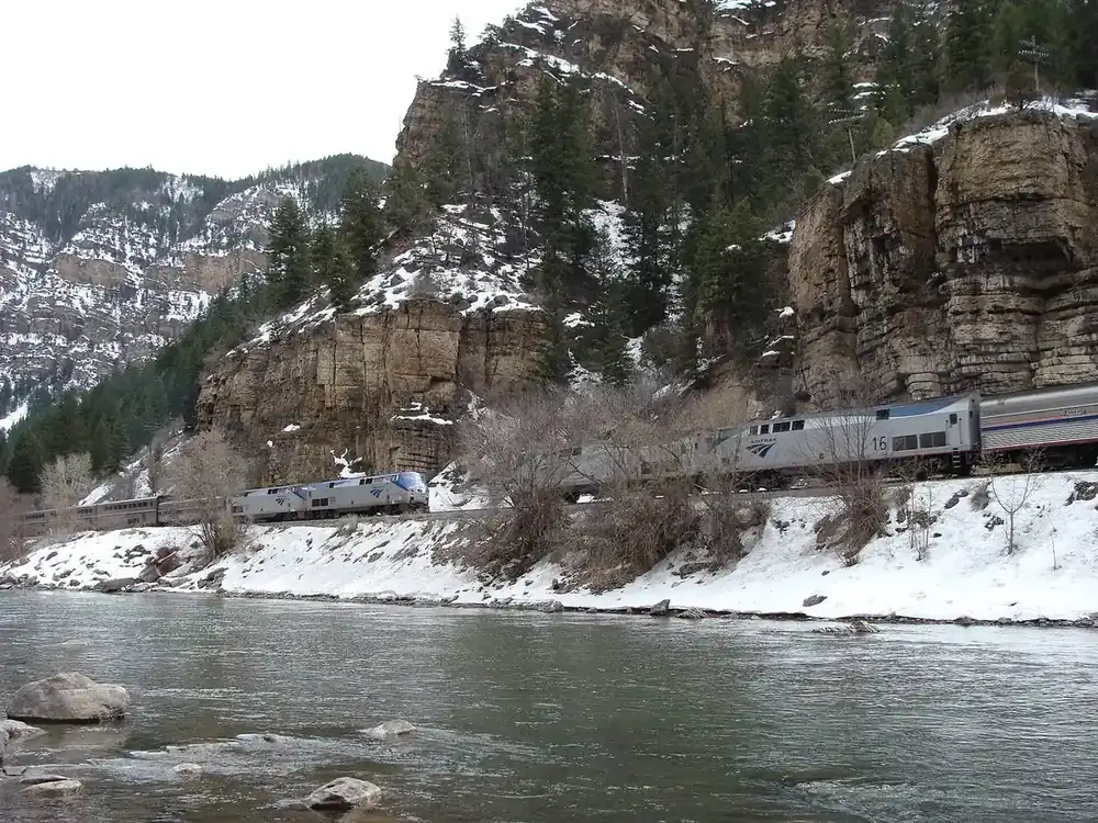 The Amtrak California Zephyr running beside the Colorado River in Glenwood Canyon