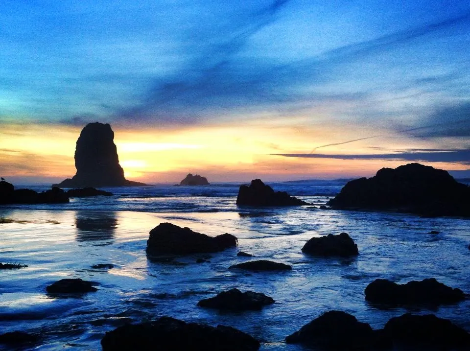 Haystack Rock glowing at dusk over Cannon Beach