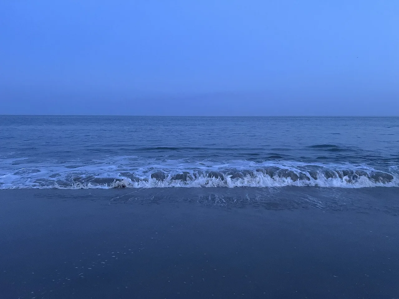 Cape May beach at dusk with the surf rolling in