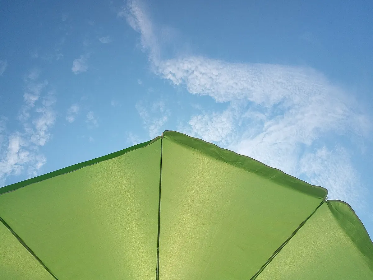 A beach umbrella against a blue Carlsbad sky
