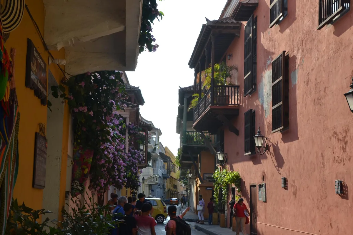 A narrow street in the walled city with wooden balconies and bougainvillea