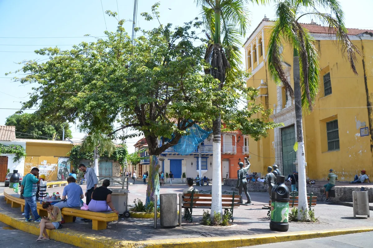 Plaza de la Trinidad in Getsemaní with trees, benches and colorful houses