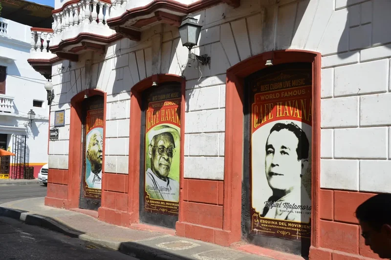 Portrait murals on a red and white wall in Getsemaní