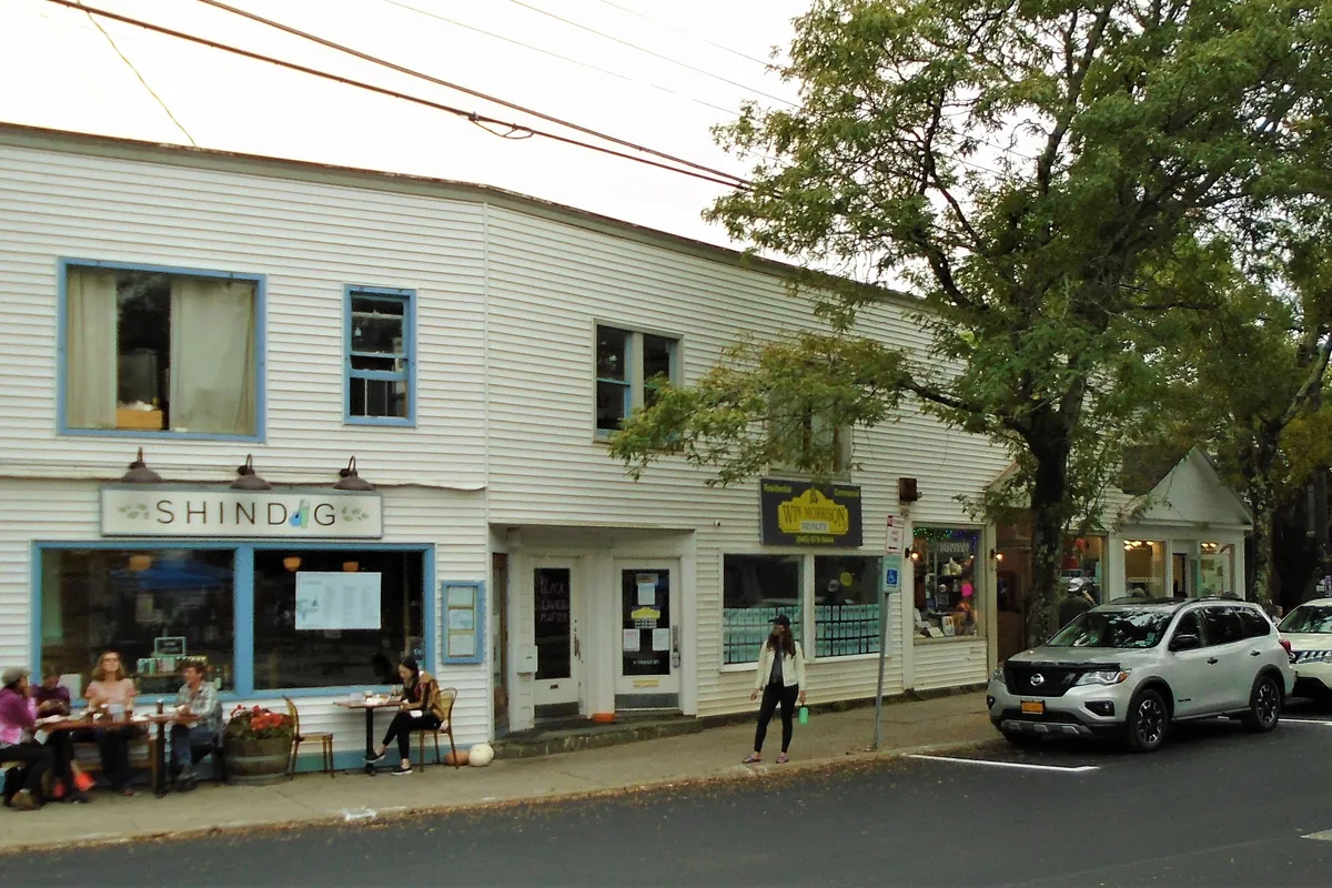 Tinker Street in Woodstock, New York, with shops and parked cars
