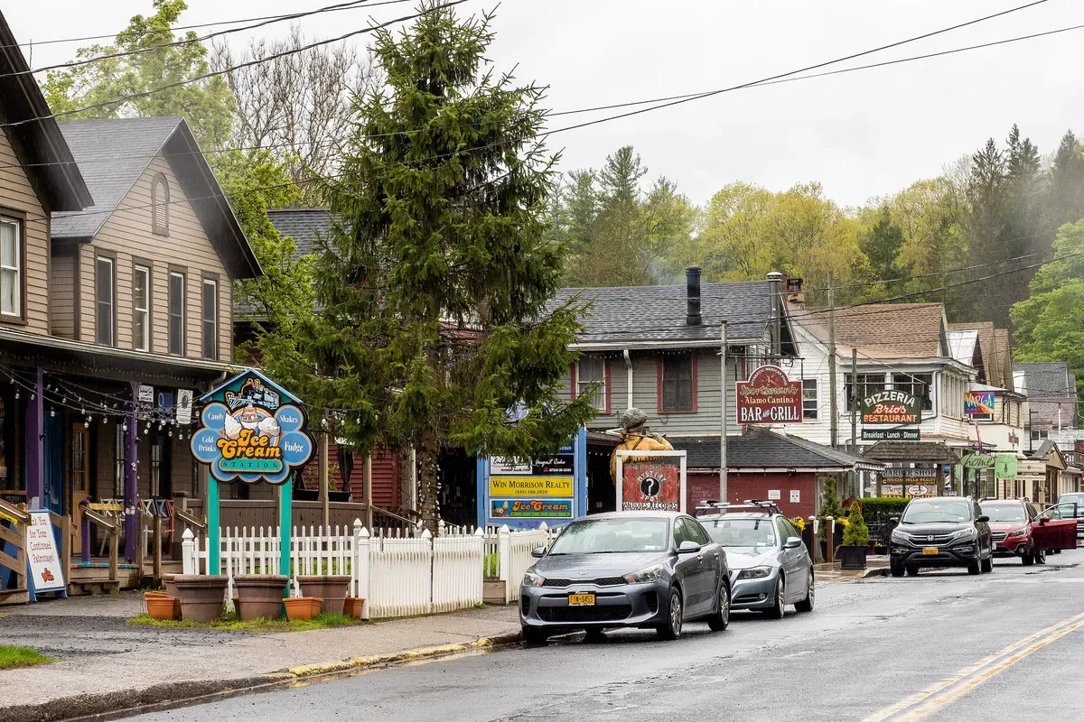 Main Street in Phoenicia, New York, with old storefronts below wooded hills