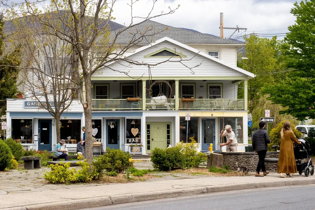 The village center of Woodstock, New York, with clapboard shopfronts and a white inn