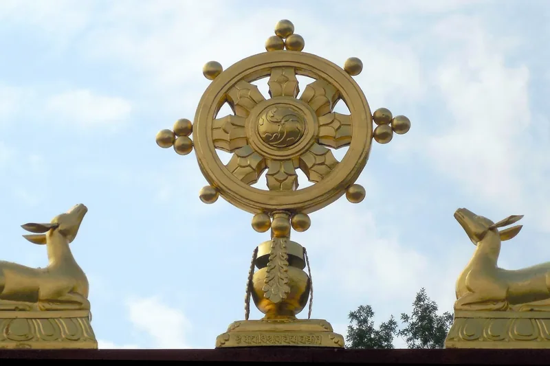 A golden Dharma wheel with two deer on the roof of the Karma Triyana Dharmachakra monastery