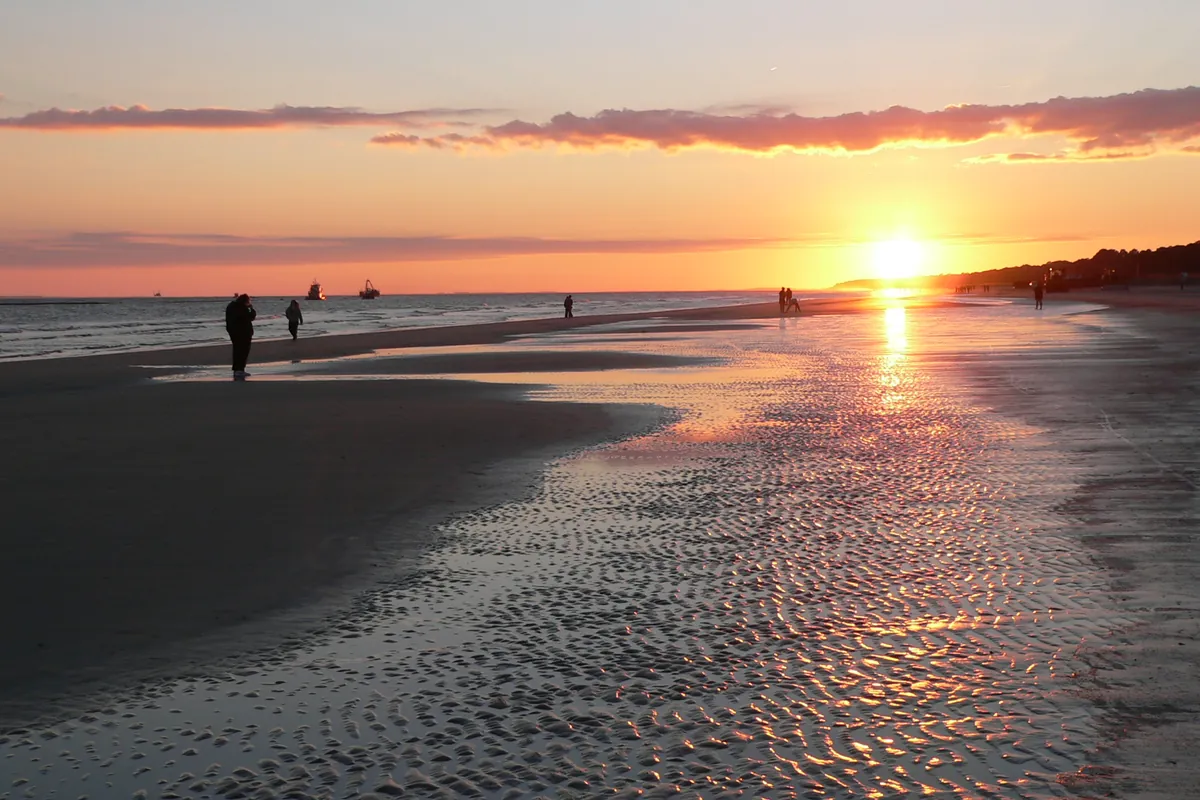 Sunset over the beach on Hilton Head Island, orange sky reflected on wet sand