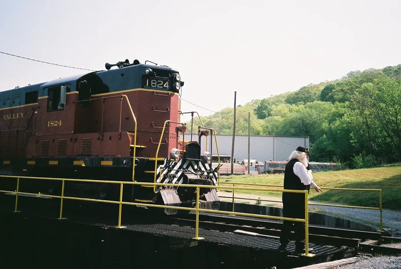 A Tennessee Valley Railroad diesel locomotive at a crossing