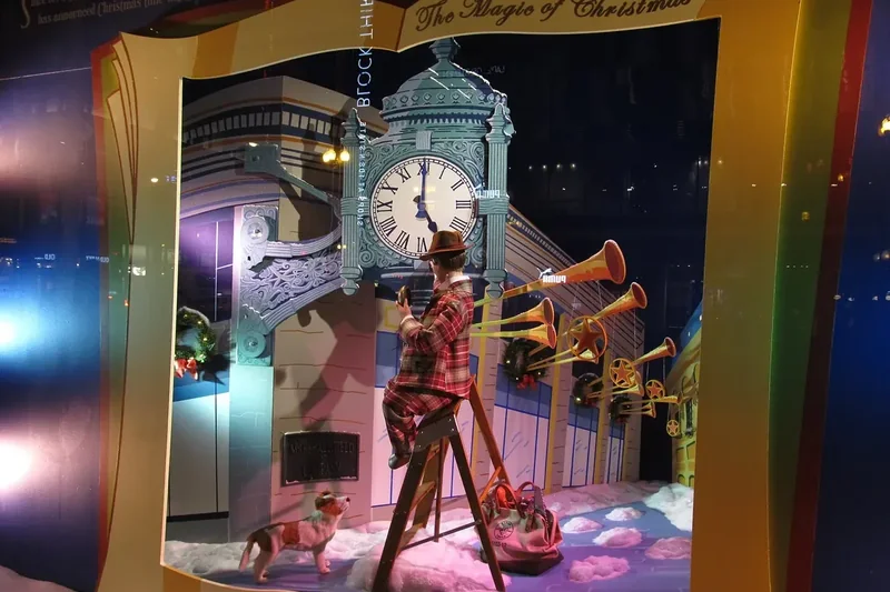 A lit holiday window display at Macy’s on State Street in Chicago