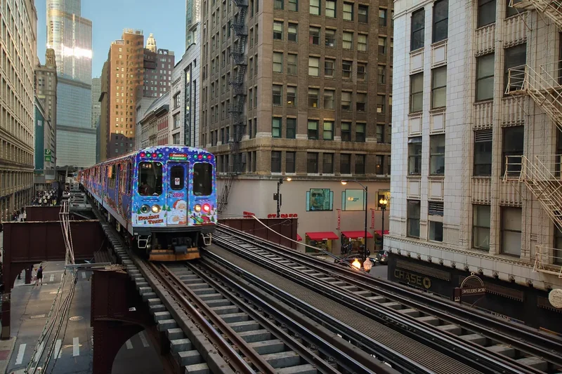The decorated CTA Holiday Train on the elevated tracks of the Loop