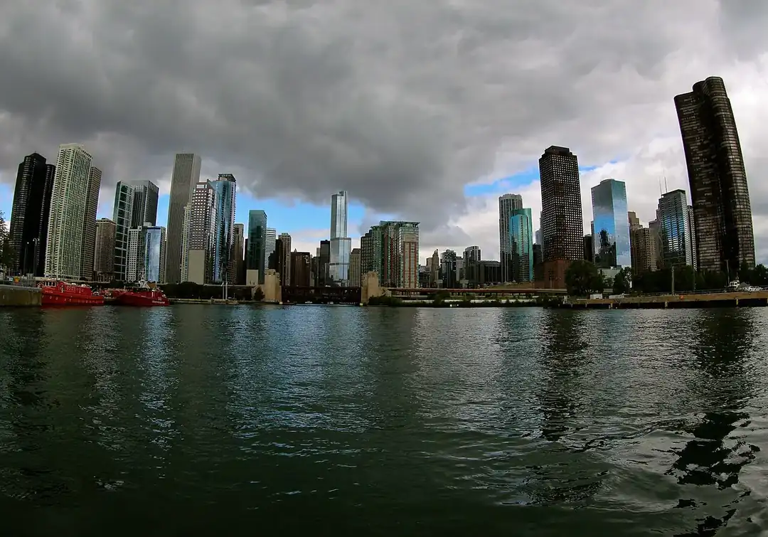 An architecture cruise boat on the Chicago River between downtown towers
