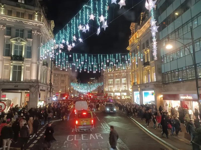 Christmas lights strung over Oxford Street at Oxford Circus with traffic below