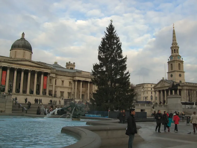 The tall Christmas tree in Trafalgar Square beside the fountains and the National Gallery