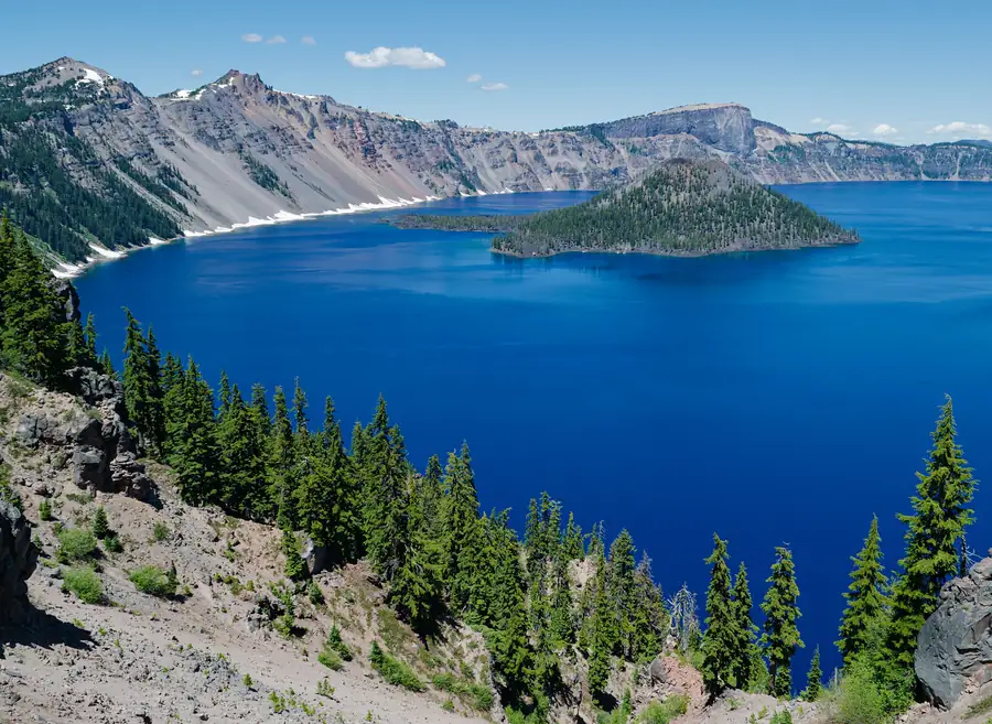 Crater Lake's deep blue water with Wizard Island and the caldera rim