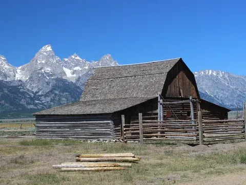 Historic barns on Mormon Row with the Grand Tetons behind
