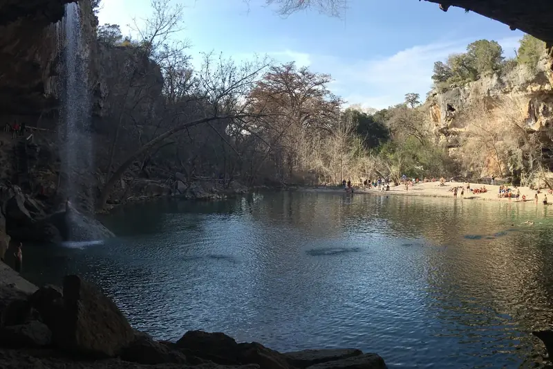 The rocky trail down to Hamilton Pool through green trees