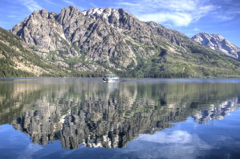 The Jenny Lake shuttle boat crossing toward Cascade Canyon beneath the Teton peaks