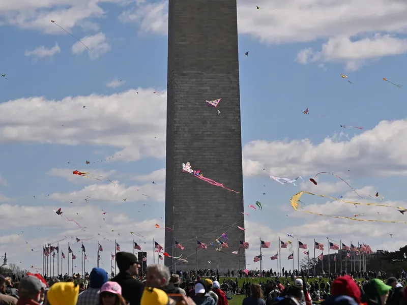 Kites flying above the crowd at the Blossom Kite Festival on the Washington Monument grounds