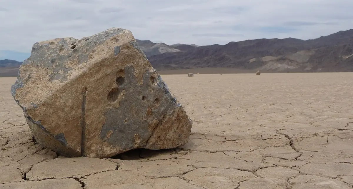 A sailing stone resting on the cracked mud of the Racetrack Playa