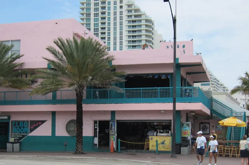 The Elbo Room, a pink and teal corner bar on Fort Lauderdale Beach Boulevard