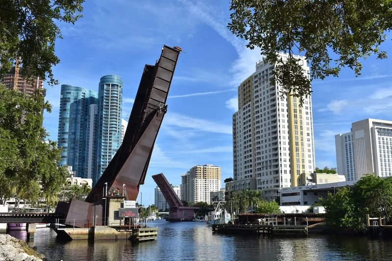 The New River in Fort Lauderdale with a raised railroad bridge and towers