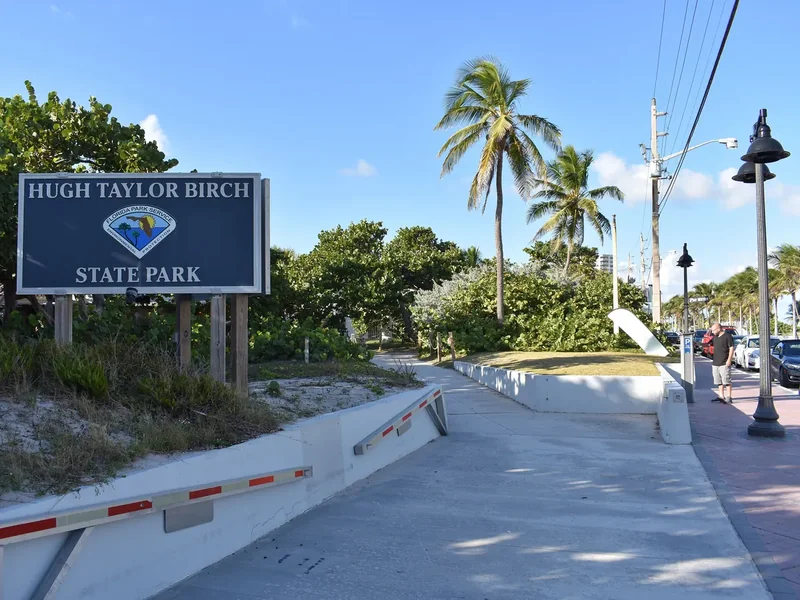 The entrance sign and path at Hugh Taylor Birch State Park