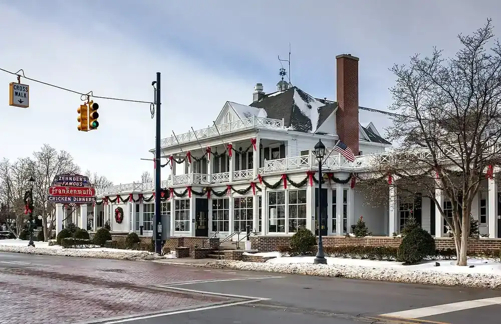 Frankenmuth's Bavarian village lit up at night with Christmas lights and snow